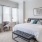 spacious, carpeted bedroom with oversized windows